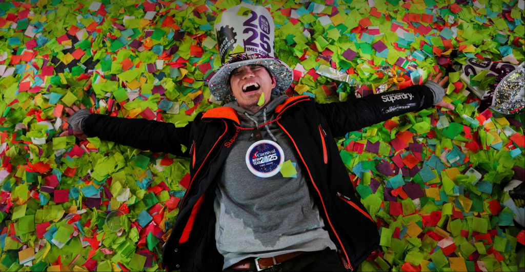 A man lies in confetti after the ball drop in Times Square on January 1. Adam Gray/Reuters