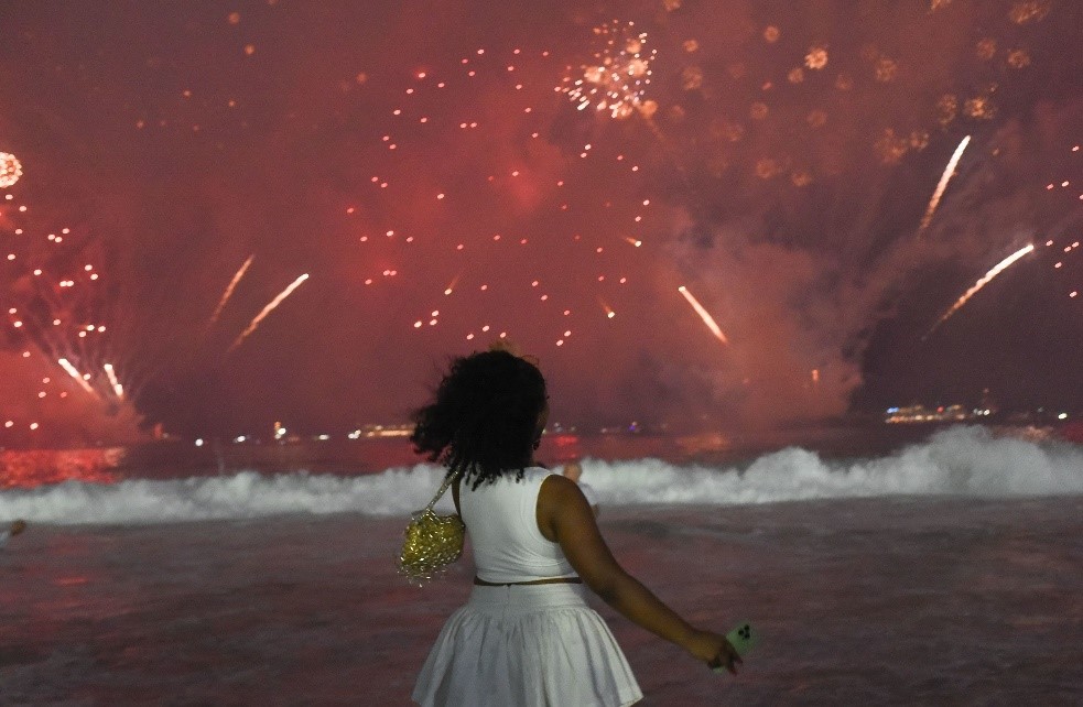 A woman watches a fireworks display on Copacabana beach in Rio de Janeiro, Brazil. Fabio Teixeira/Anadolu/Getty Images