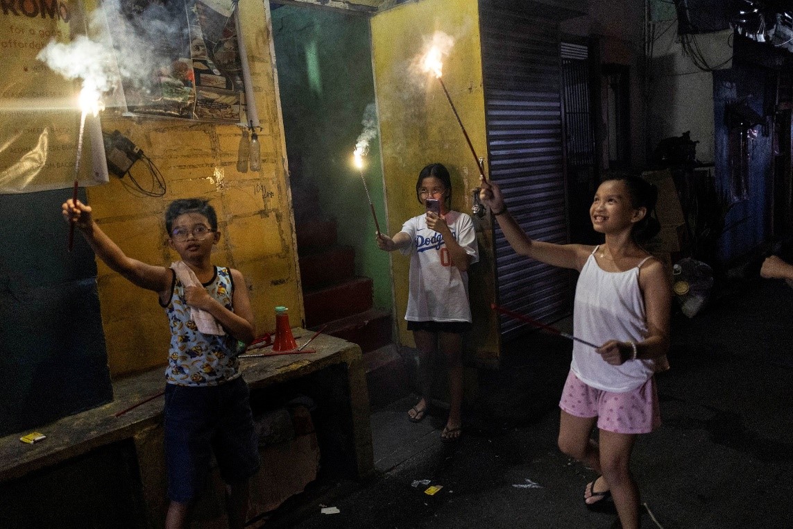 Children light firecrackers on a street in Mandaluyong. Eloisa Lopez/Reuters