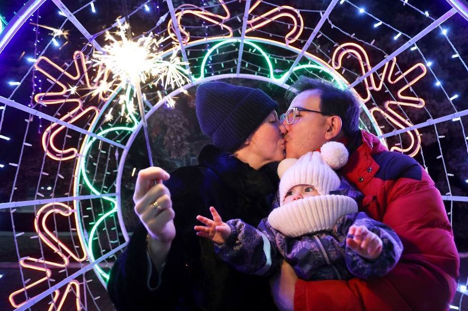 A couple shares a tender moment as they walk with their child in Donetsk, Ukraine. Alexei Alexandrov/AP